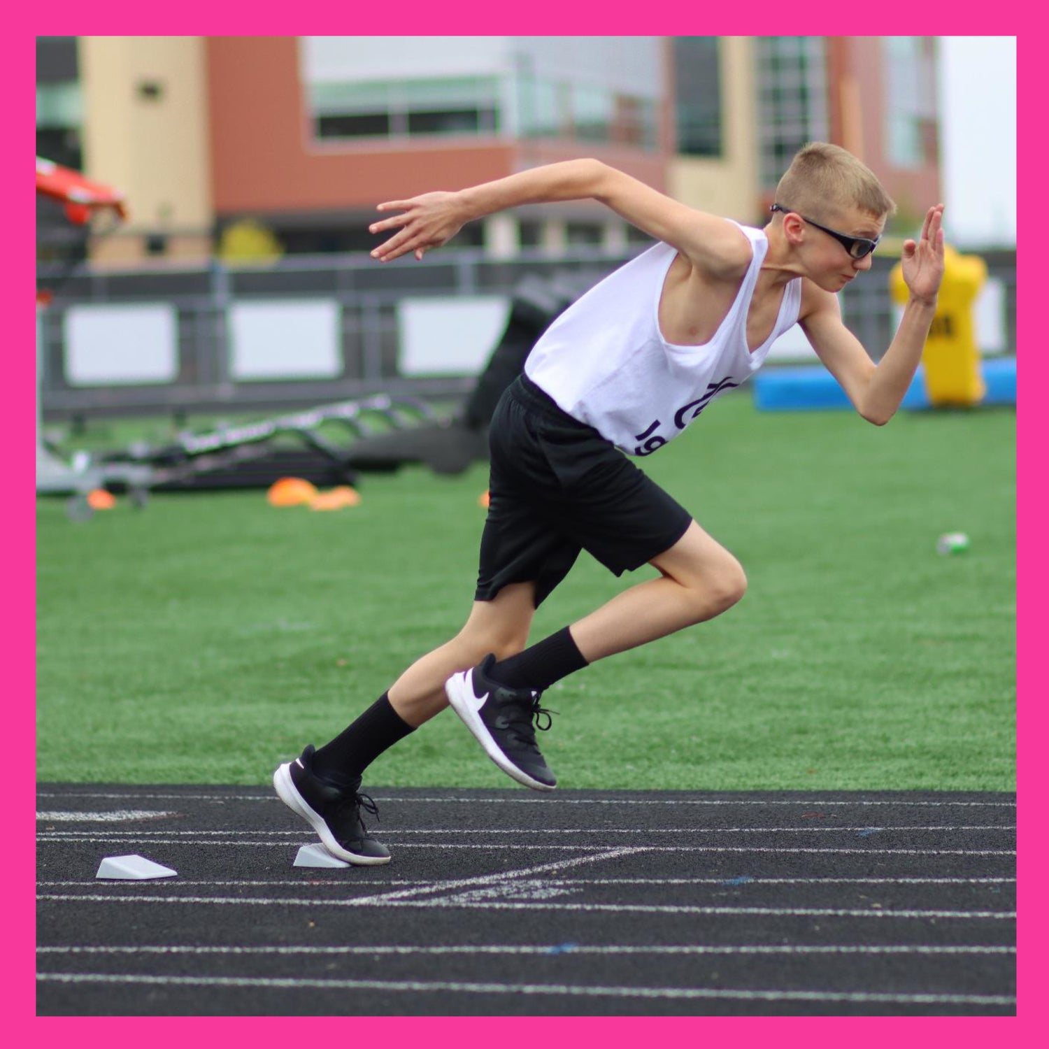 youth runner exploding out of portable track starting blocks