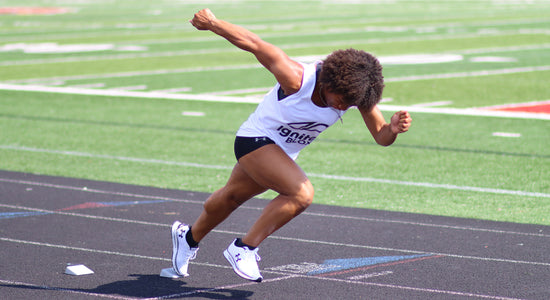 Female using portable track starting blocks