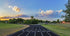track lanes with trees and clouds in the background