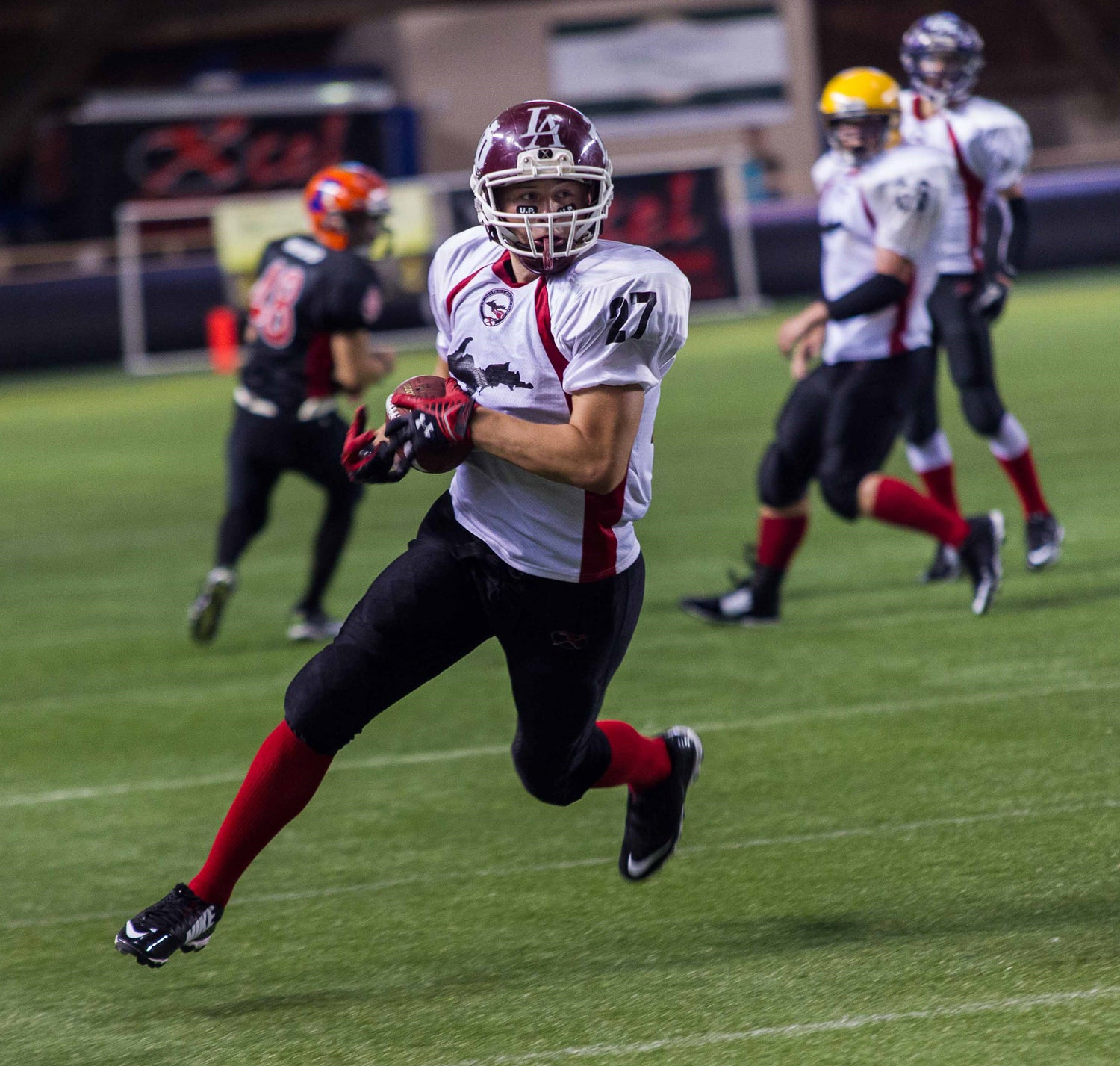 football player running with the ball for a touchdown